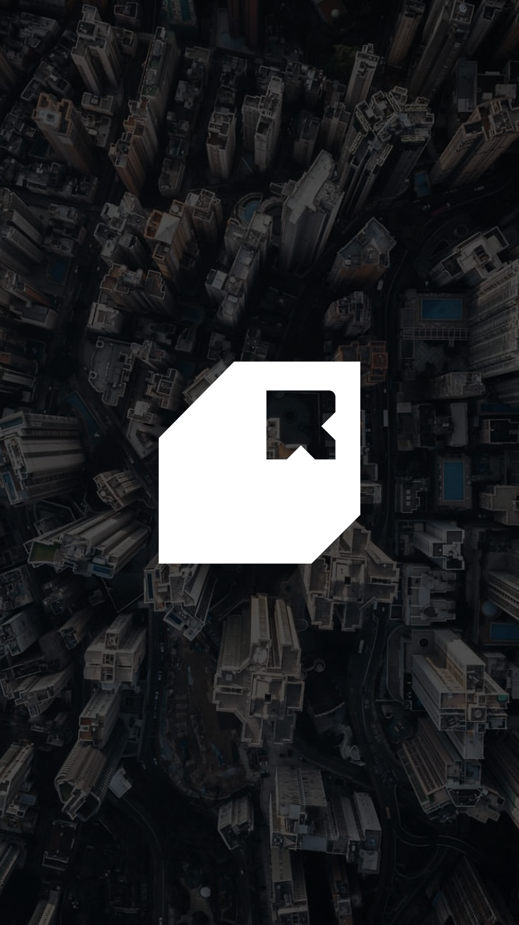 The Cornerstone — chamfered R mark dropped into an aerial city